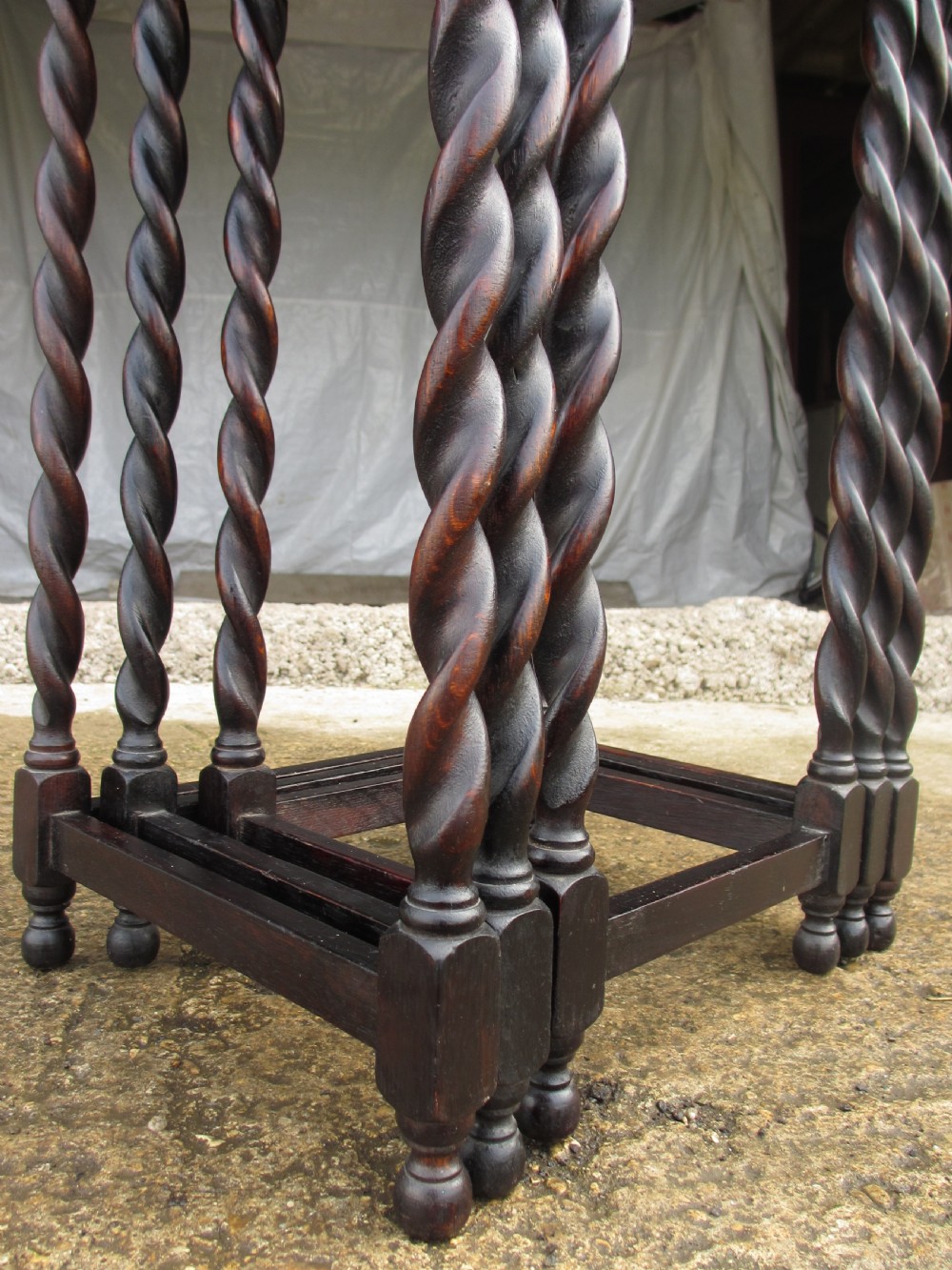 A nest of three dark oak square-topped side tables featuring carved barley twist legs and low stretchers. View IV