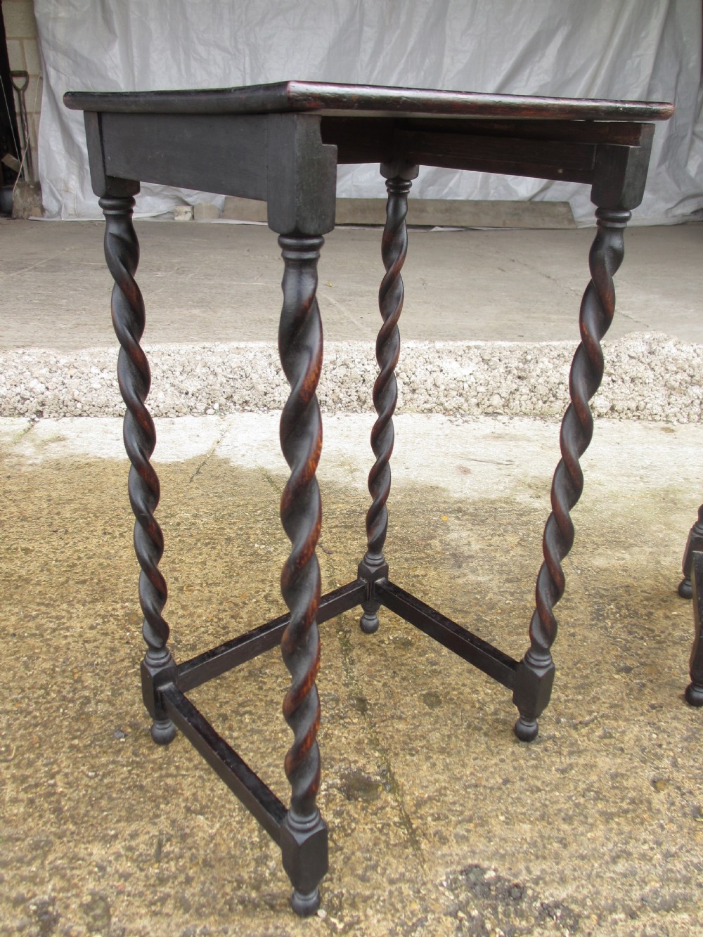 A nest of three dark oak square-topped side tables featuring carved barley twist legs and low stretchers. View VIII
