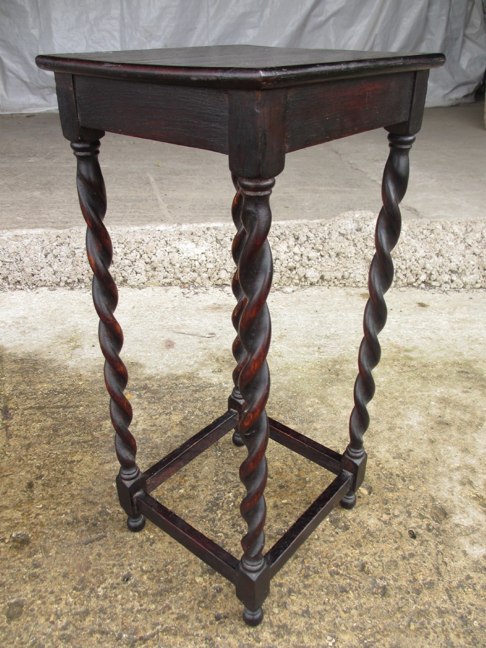 A nest of three dark oak square-topped side tables featuring carved barley twist legs and low stretchers. View IX