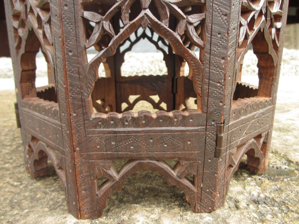 A pair of 19th-century Anglo-Indian padauk wood occasional tables featuring circular tops with deep foliate carvings and central bone inlay set upon collapsible octagonal pierced fretwork bases. View V