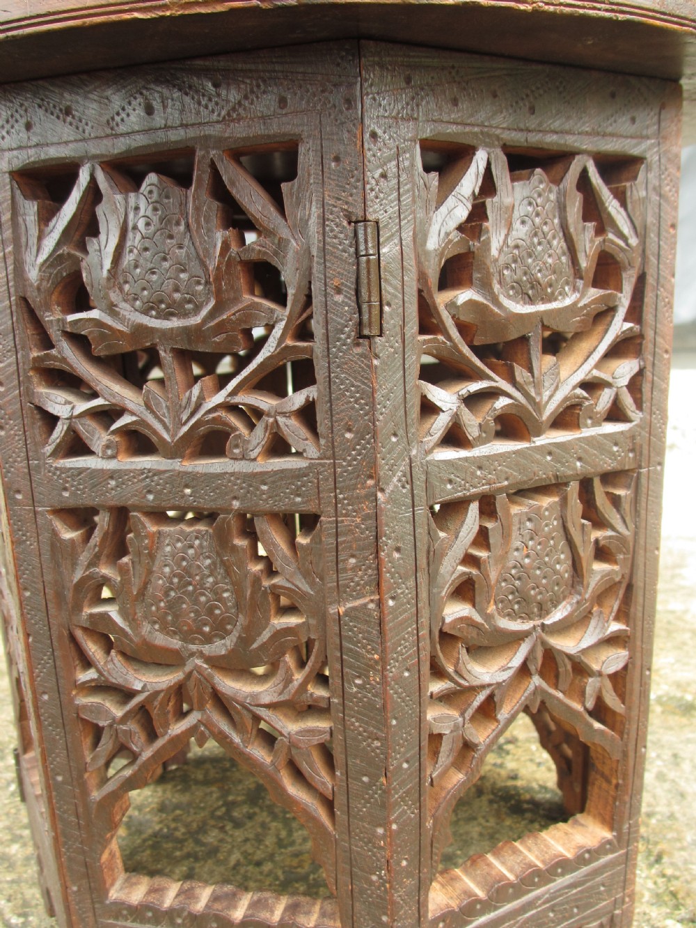 A pair of 19th-century Anglo-Indian padauk wood occasional tables featuring circular tops with deep foliate carvings and central bone inlay set upon collapsible octagonal pierced fretwork bases. View VI