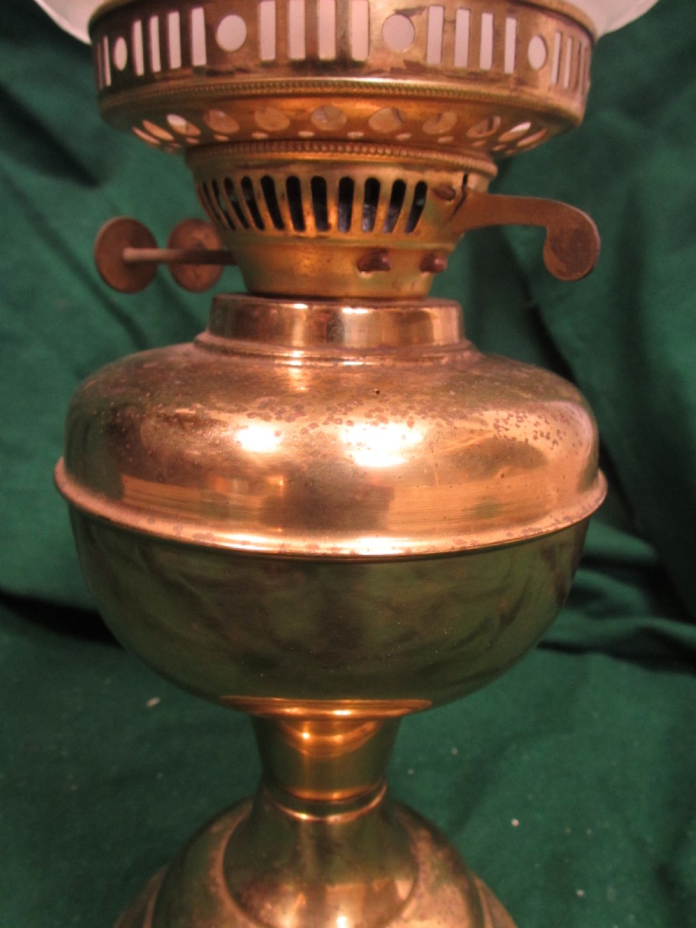 A Victorian oil lamp featuring a brass pedestal base and reservoir, a frosted glass shade with a frilled rim and floral relief patterns, and a clear glass chimney. View V