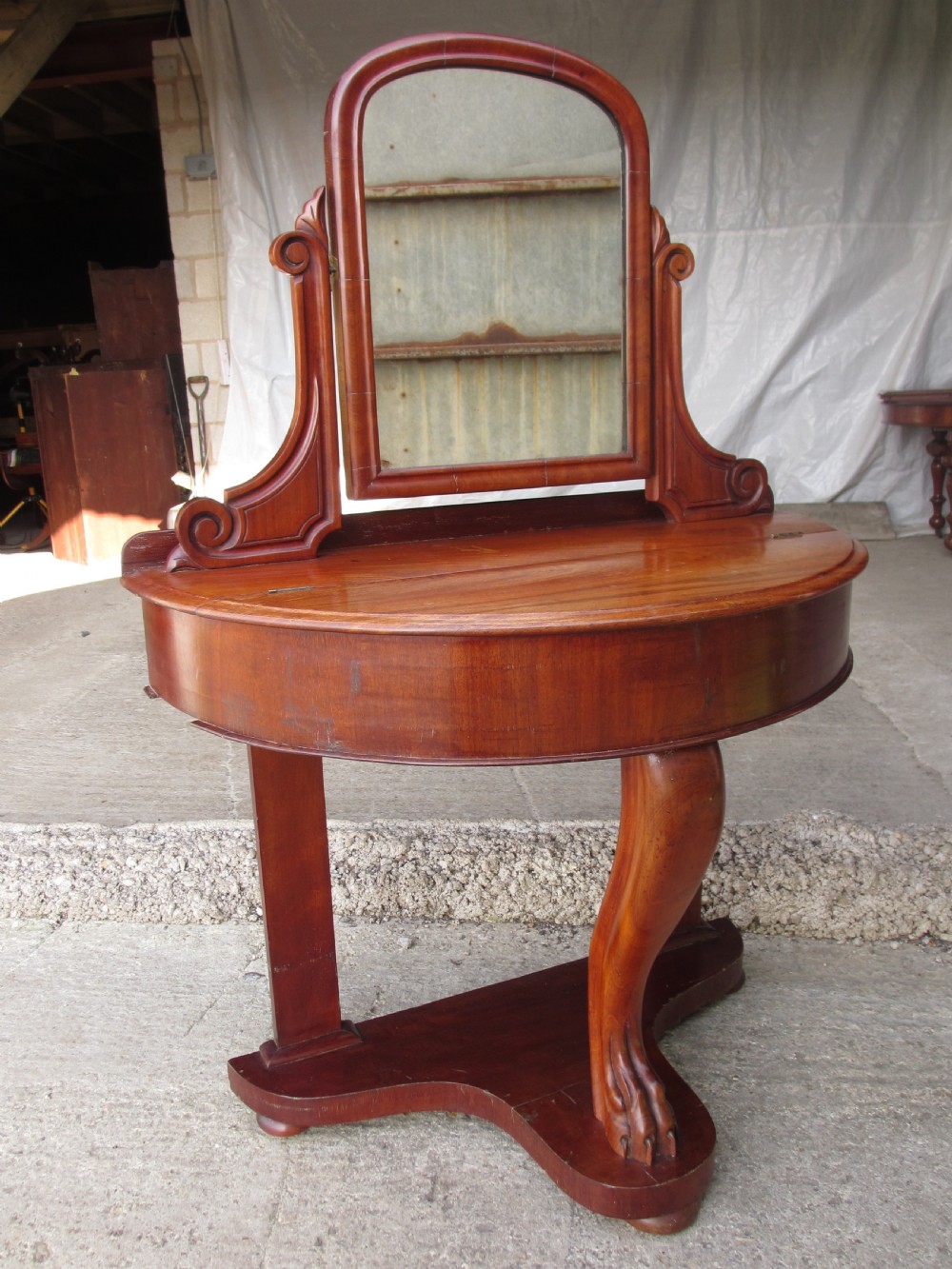 Victorian mahogany demi-lune dressing table featuring an arched swing mirror flanked by scrolled supports and a central carved cabriole front leg. View III