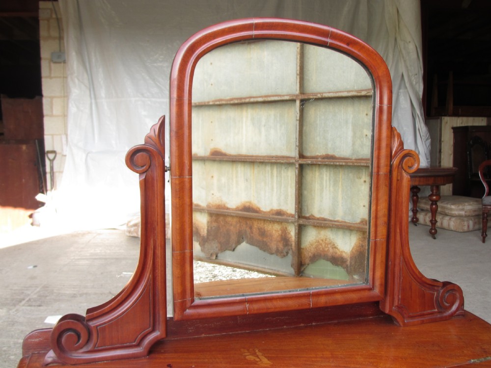Victorian mahogany demi-lune dressing table featuring an arched swing mirror flanked by scrolled supports and a central carved cabriole front leg. View V