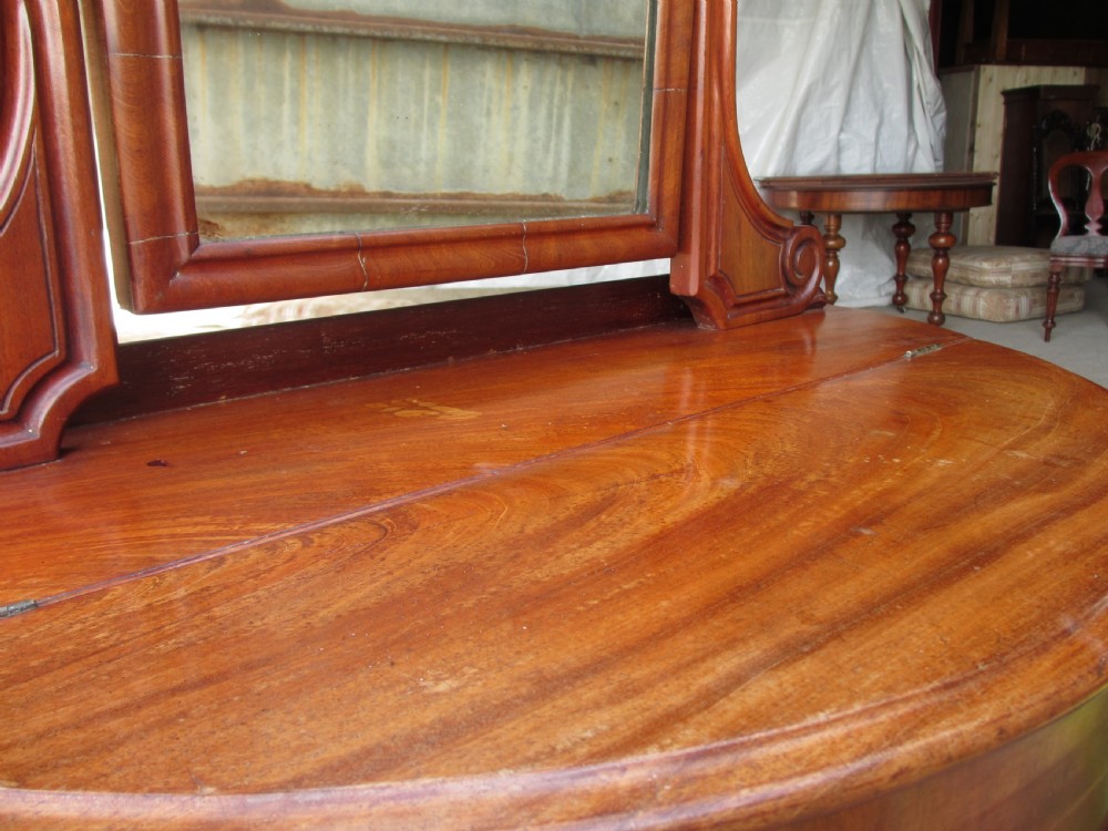 Victorian mahogany demi-lune dressing table featuring an arched swing mirror flanked by scrolled supports and a central carved cabriole front leg. View VIII