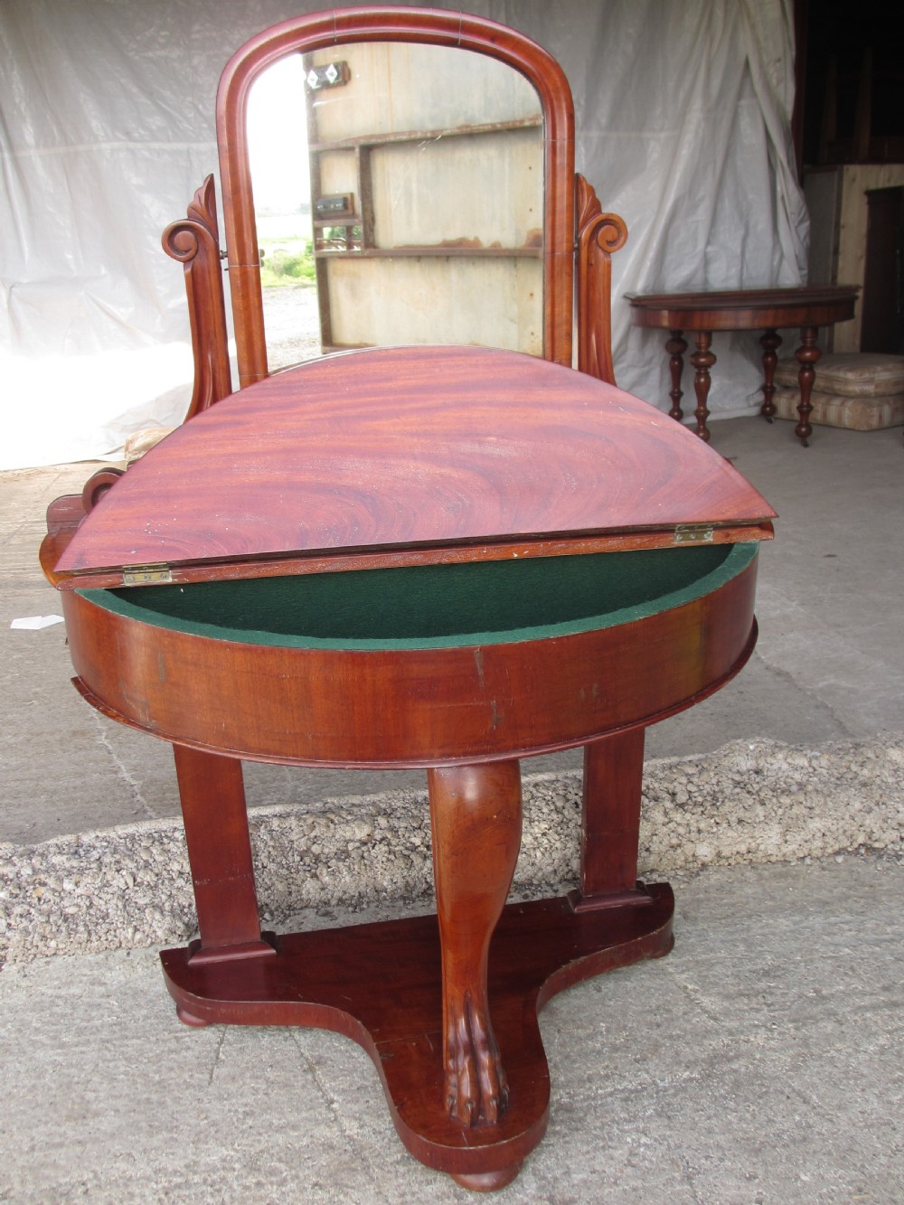 Victorian mahogany demi-lune dressing table featuring an arched swing mirror flanked by scrolled supports and a central carved cabriole front leg. View X