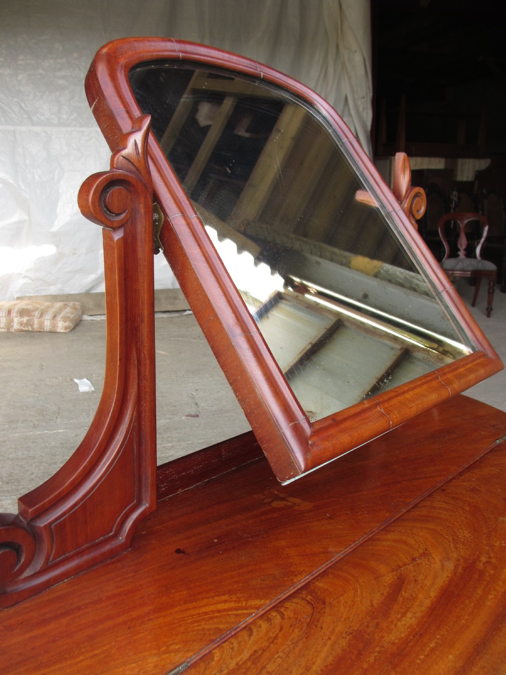 Victorian mahogany demi-lune dressing table featuring an arched swing mirror flanked by scrolled supports and a central carved cabriole front leg. View XII