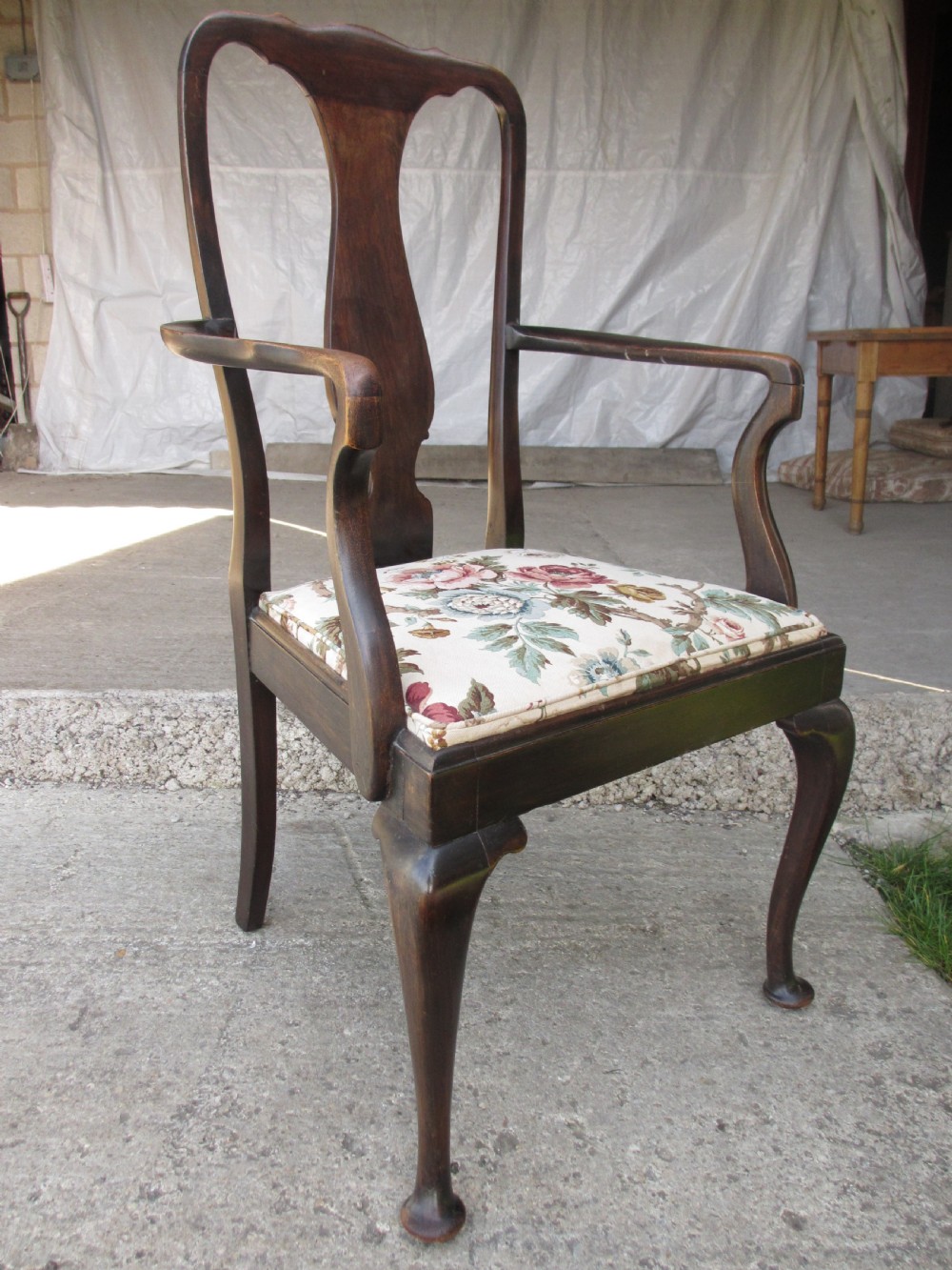 A 19th-century dark mahogany carver armchair featuring a shaped vase back splat, cabriole front legs with pad feet, and a drop-in floral tapestry seat pad. View II