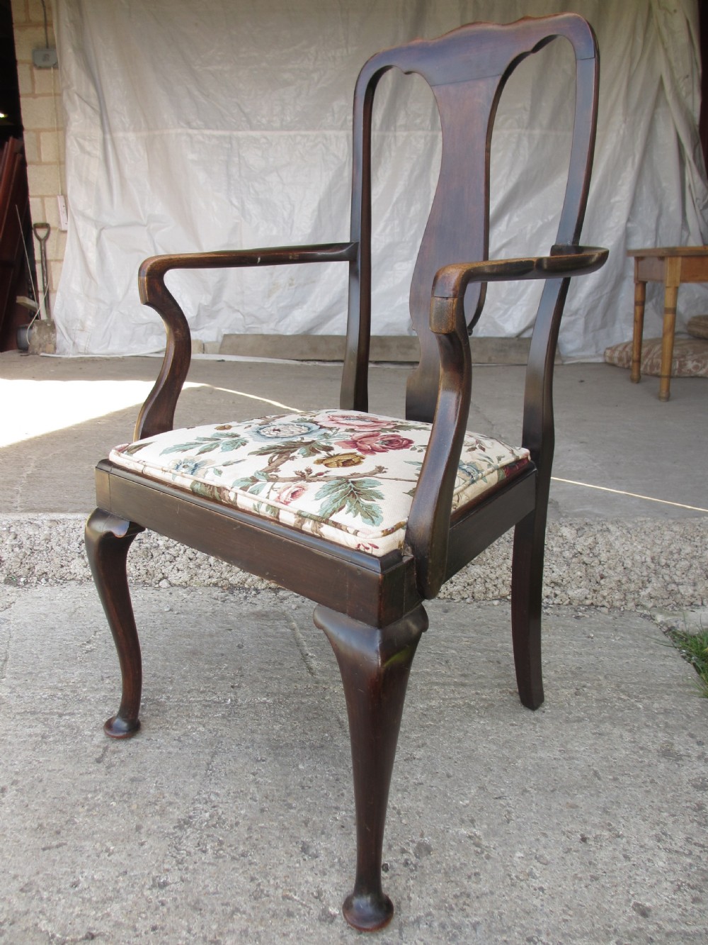 A 19th-century dark mahogany carver armchair featuring a shaped vase back splat, cabriole front legs with pad feet, and a drop-in floral tapestry seat pad. View III