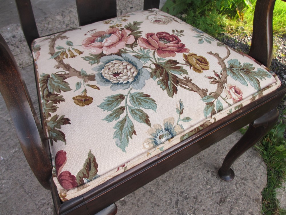 A 19th-century dark mahogany carver armchair featuring a shaped vase back splat, cabriole front legs with pad feet, and a drop-in floral tapestry seat pad. View VIII