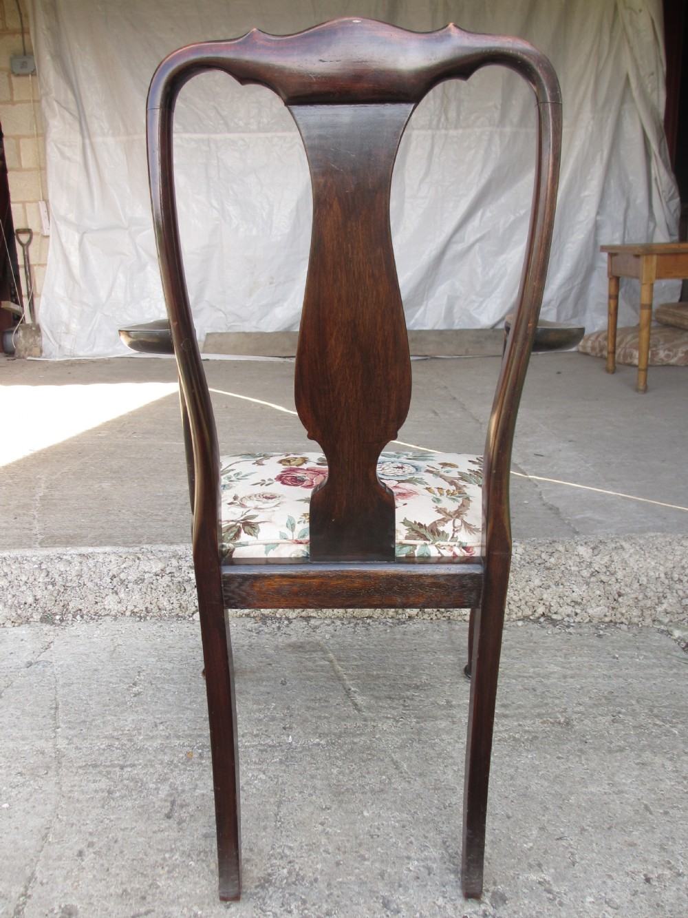 A 19th-century dark mahogany carver armchair featuring a shaped vase back splat, cabriole front legs with pad feet, and a drop-in floral tapestry seat pad. View XI