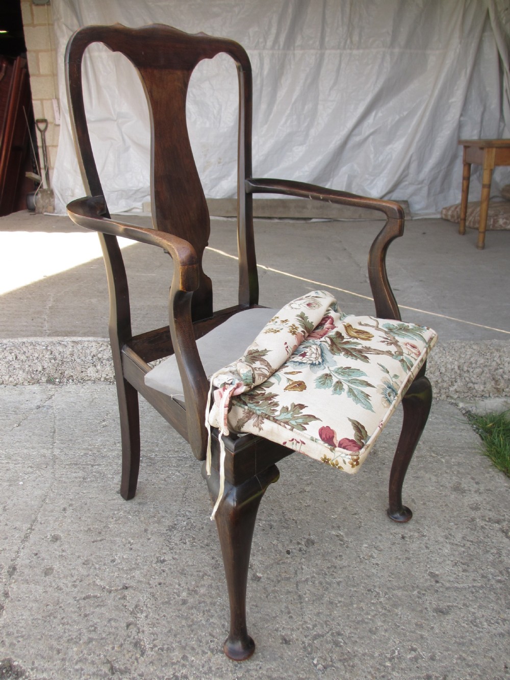 A 19th-century dark mahogany carver armchair featuring a shaped vase back splat, cabriole front legs with pad feet, and a drop-in floral tapestry seat pad. View XII