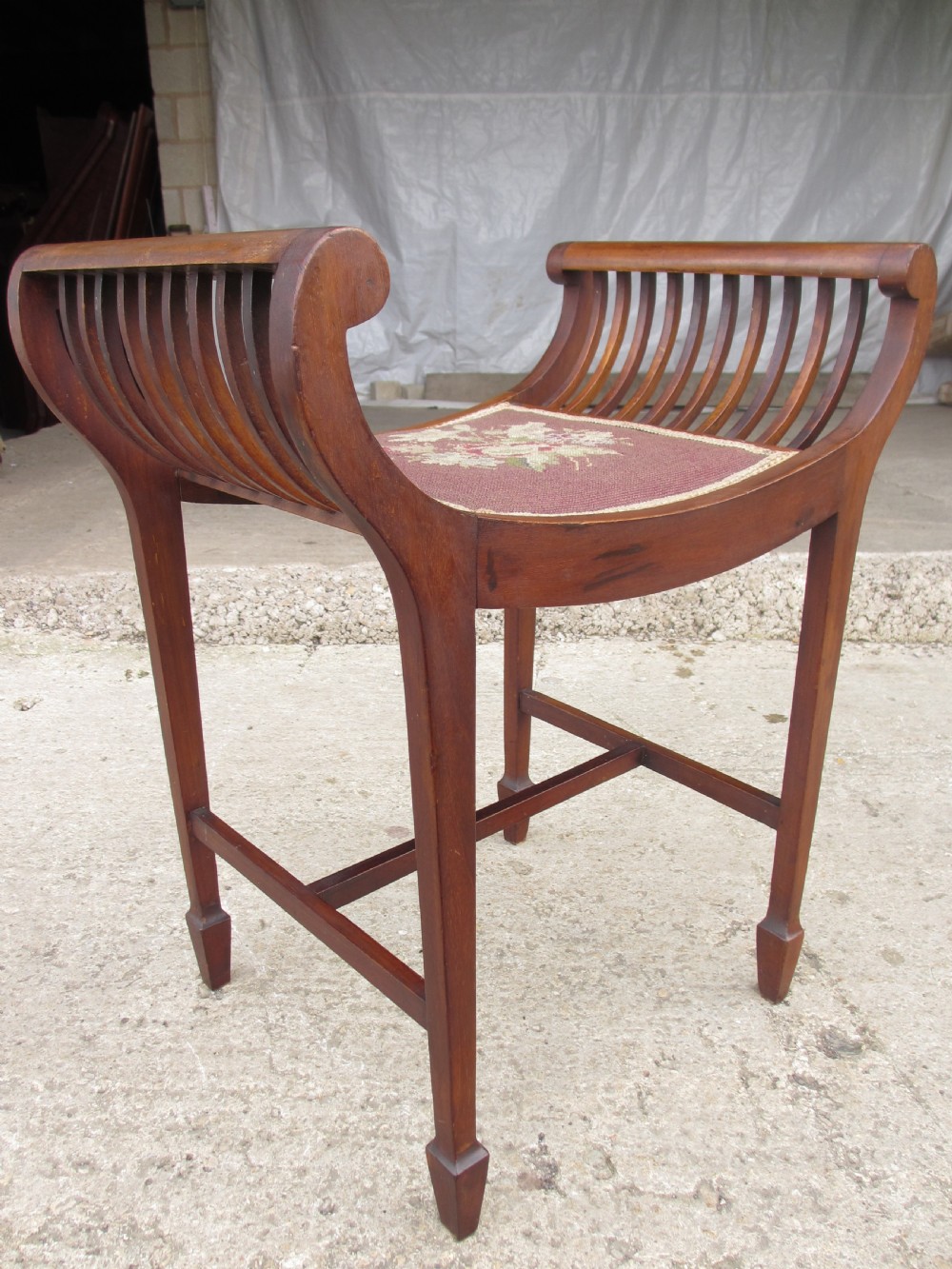 Edwardian mahogany cradle shaped piano stool with tapering legs View II