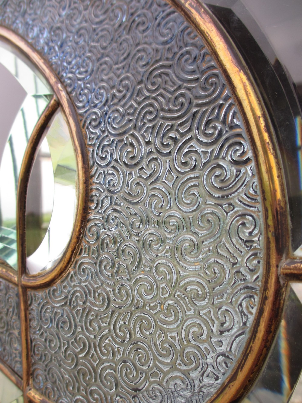 A late 19th-century mahogany Art Nouveau display cabinet featuring leaded glass doors with green accents, stylized glazing bars, interior glass shelving, and a lower open undertier. View IV