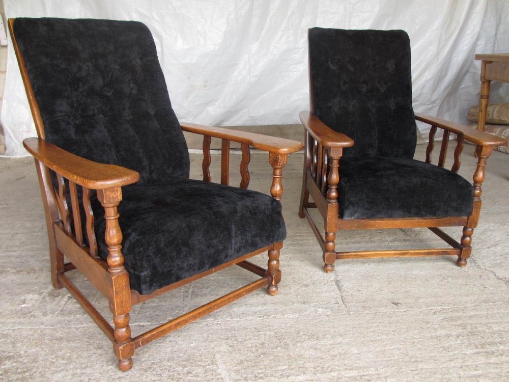 A pair of Edwardian oak plantation style Art Deco adjustable lean back armchairs View II