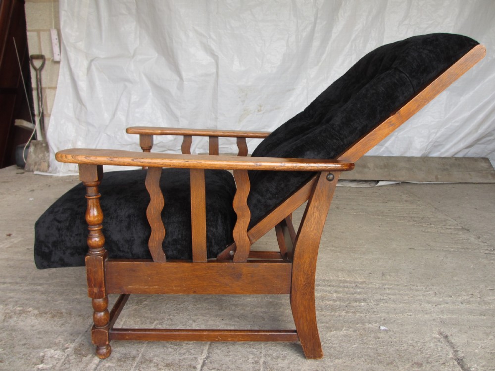 A pair of Edwardian oak plantation style Art Deco adjustable lean back armchairs View X