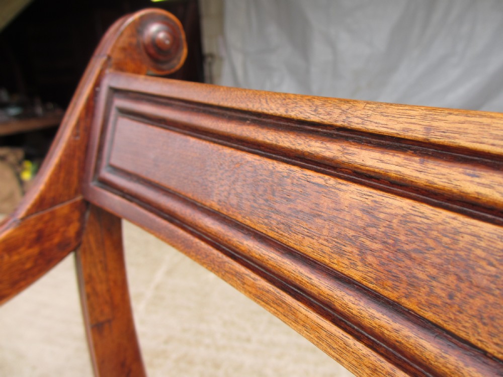 A Georgian mahogany armchair featuring curved reeded arms, a carved rope-twist horizontal back bar, turned front supports, and a tan drop-in upholstered seat. View III