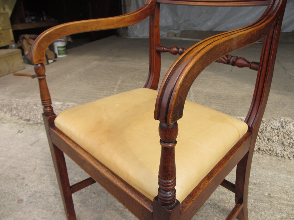 A Georgian mahogany armchair featuring curved reeded arms, a carved rope-twist horizontal back bar, turned front supports, and a tan drop-in upholstered seat. View VIII