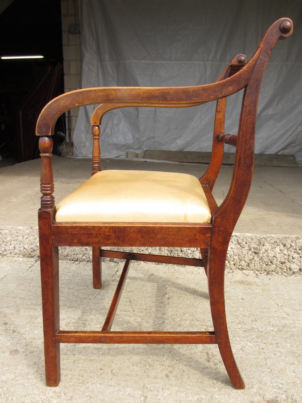 A Georgian mahogany armchair featuring curved reeded arms, a carved rope-twist horizontal back bar, turned front supports, and a tan drop-in upholstered seat. View XI