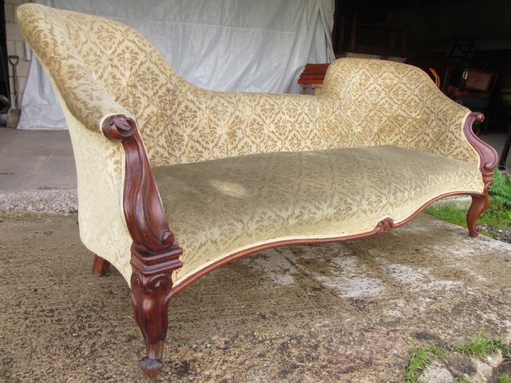 An early Victorian mahogany showood sofa with button-tufted gold damask upholstery and carved cabriole legs. View II