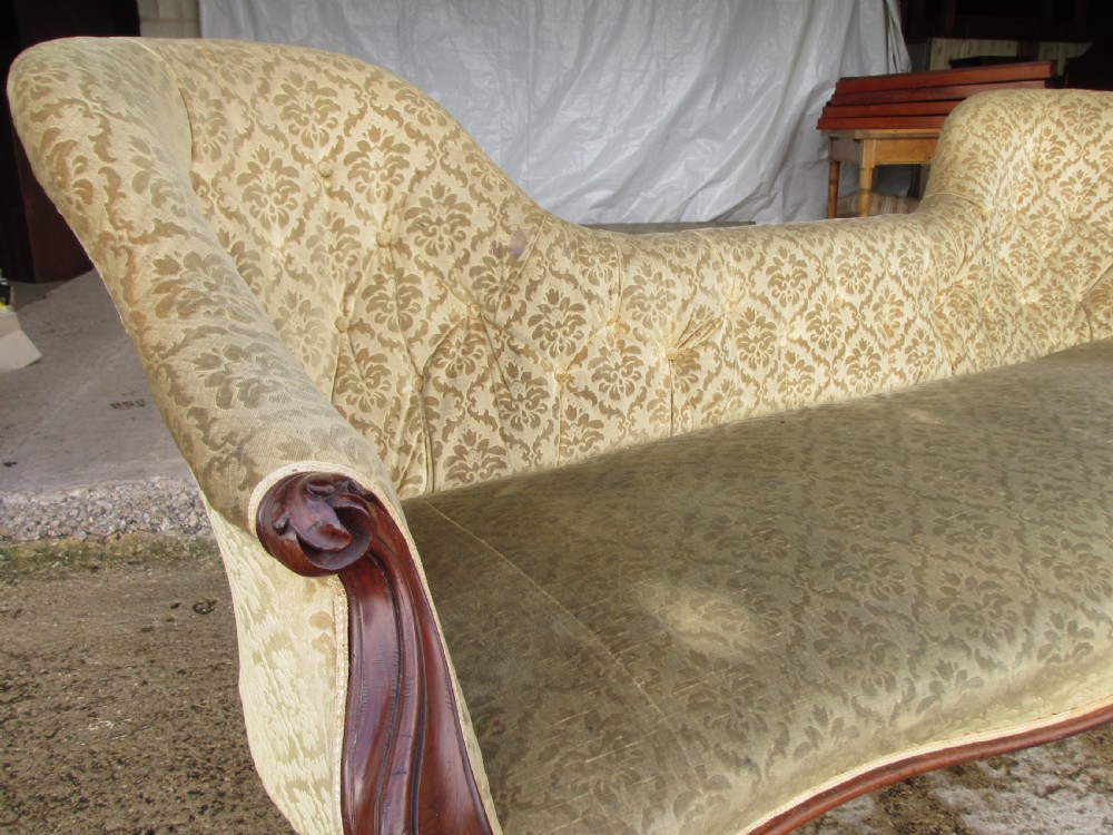An early Victorian mahogany showood sofa with button-tufted gold damask upholstery and carved cabriole legs. View III