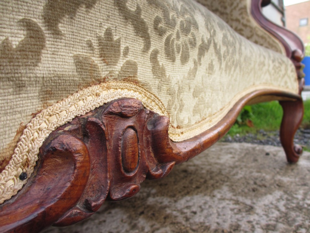 An early Victorian mahogany showood sofa with button-tufted gold damask upholstery and carved cabriole legs. View IV
