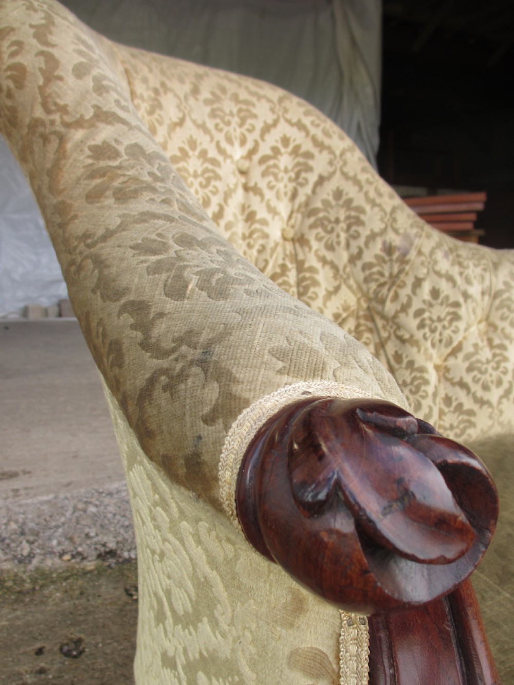 An early Victorian mahogany showood sofa with button-tufted gold damask upholstery and carved cabriole legs. View VIII