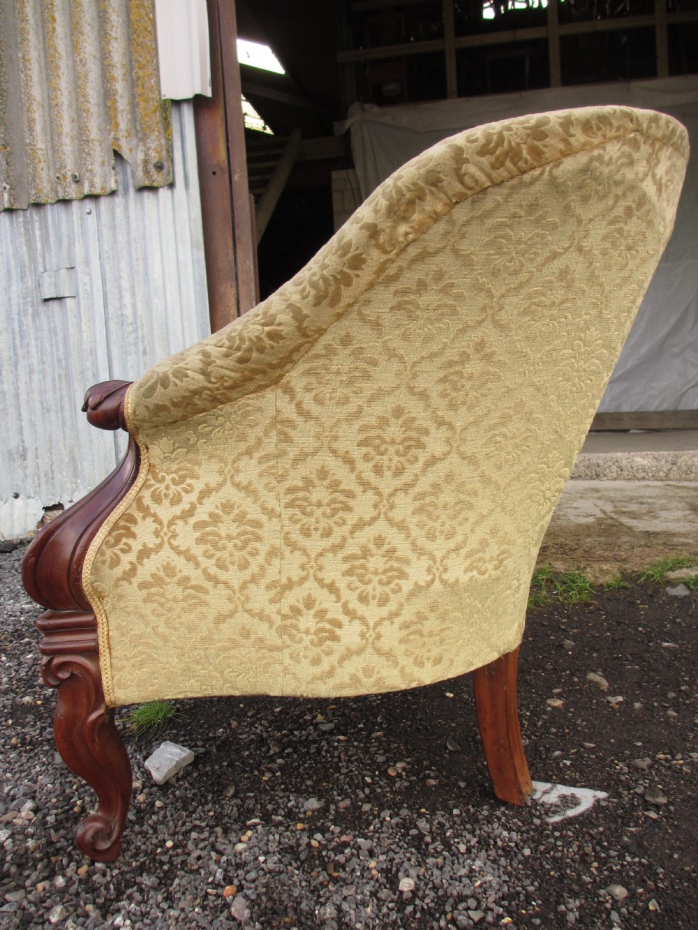 An early Victorian mahogany showood sofa with button-tufted gold damask upholstery and carved cabriole legs. View IX