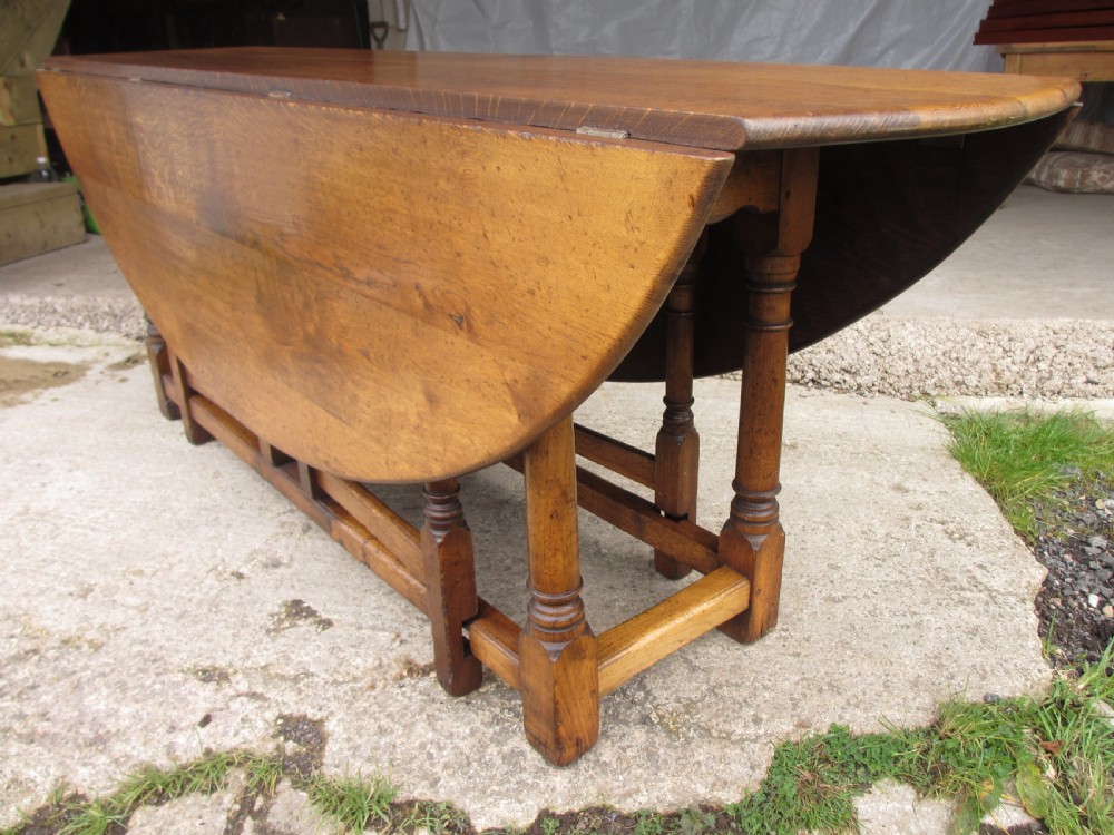 Early 20th century large golden oak wake oval drop leaf dining table View II
