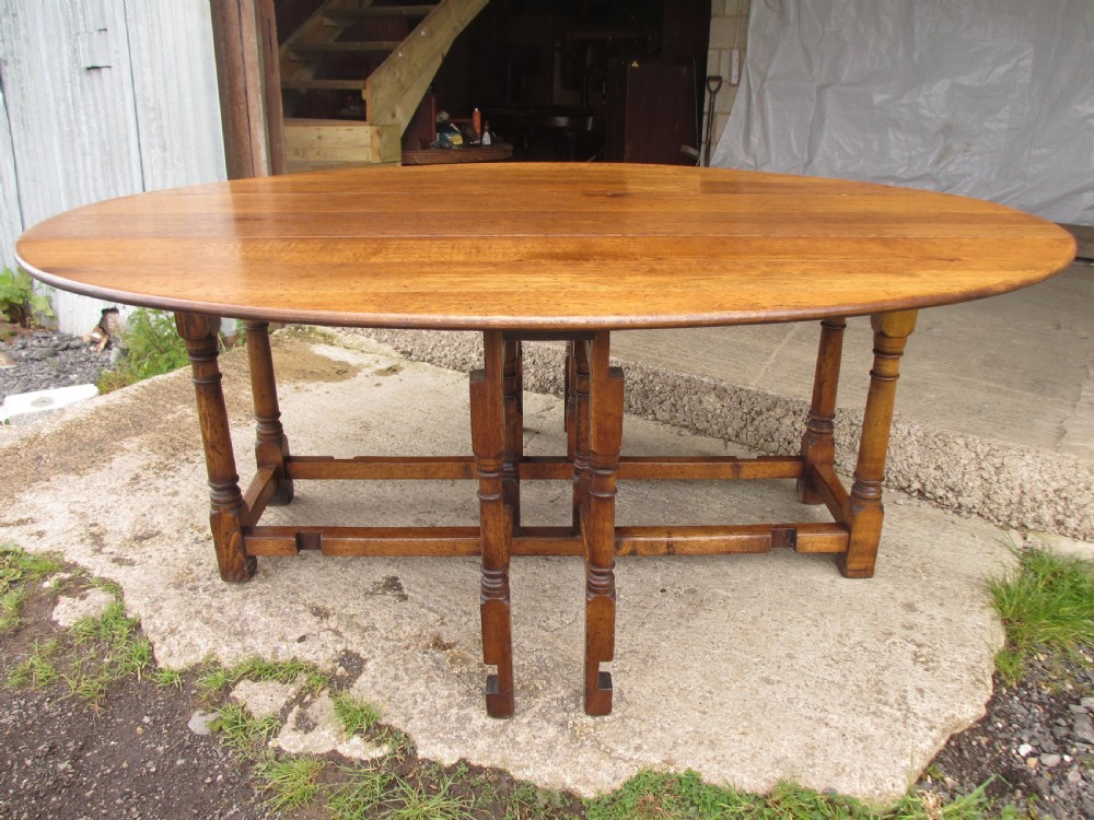 Early 20th century large golden oak wake oval drop leaf dining table View III