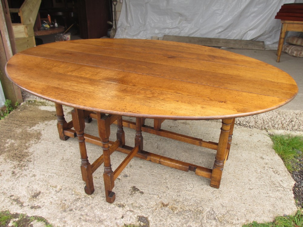 Early 20th century large golden oak wake oval drop leaf dining table View V