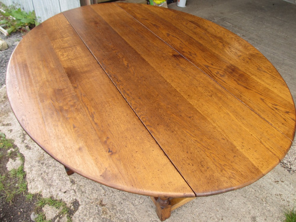 Early 20th century large golden oak wake oval drop leaf dining table View VI
