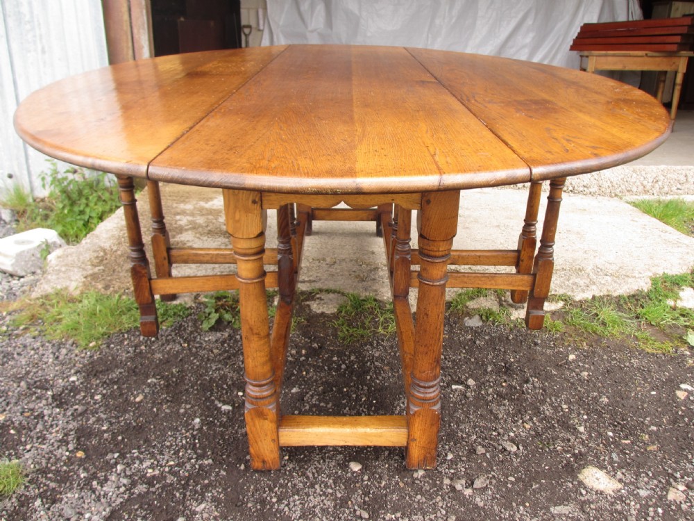 Early 20th century large golden oak wake oval drop leaf dining table View X