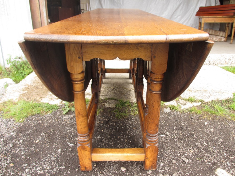 Early 20th century large golden oak wake oval drop leaf dining table View XII