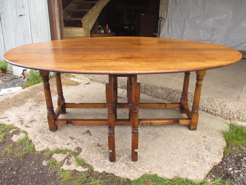 Early 20th century large golden oak wake oval drop leaf dining table