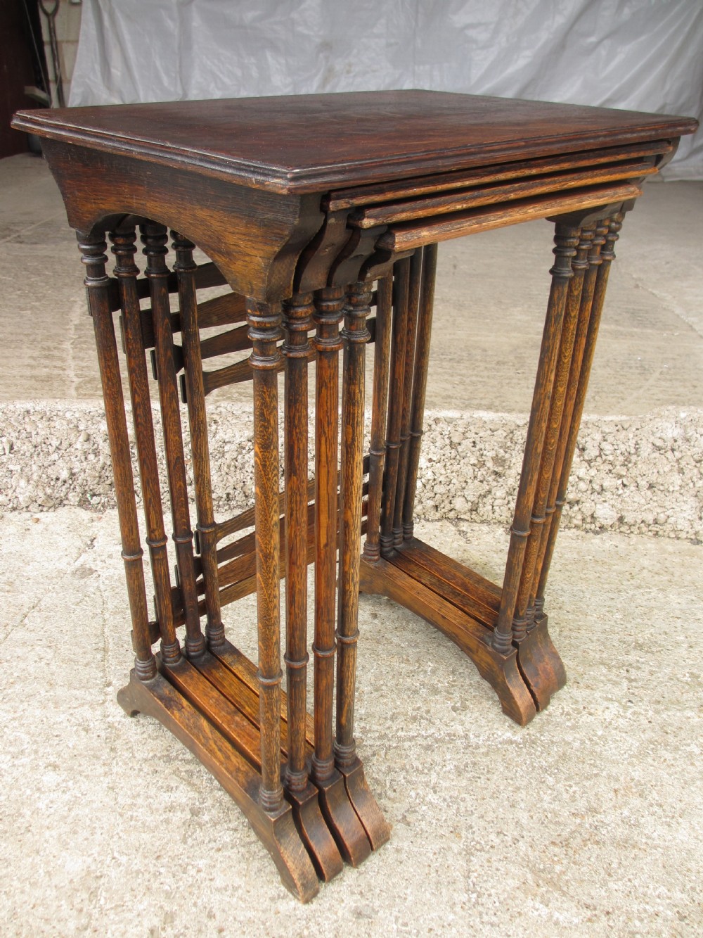 A set of four graduating nineteenth-century oak nesting tables with slender turned legs and rectangular tops. View IX