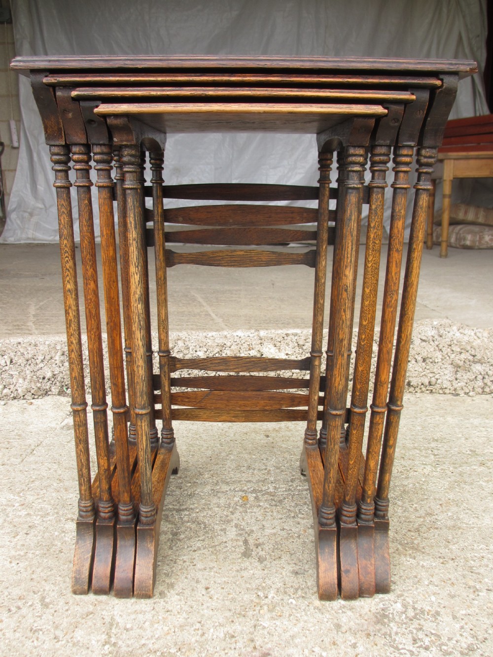 A set of four graduating nineteenth-century oak nesting tables with slender turned legs and rectangular tops. View II
