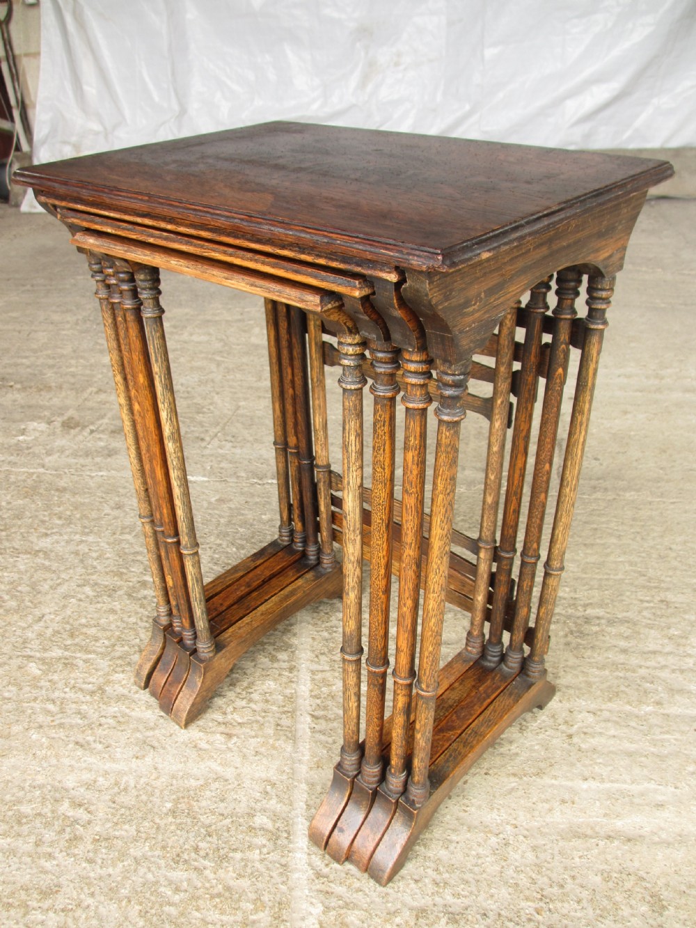 A set of four graduating nineteenth-century oak nesting tables with slender turned legs and rectangular tops. View III