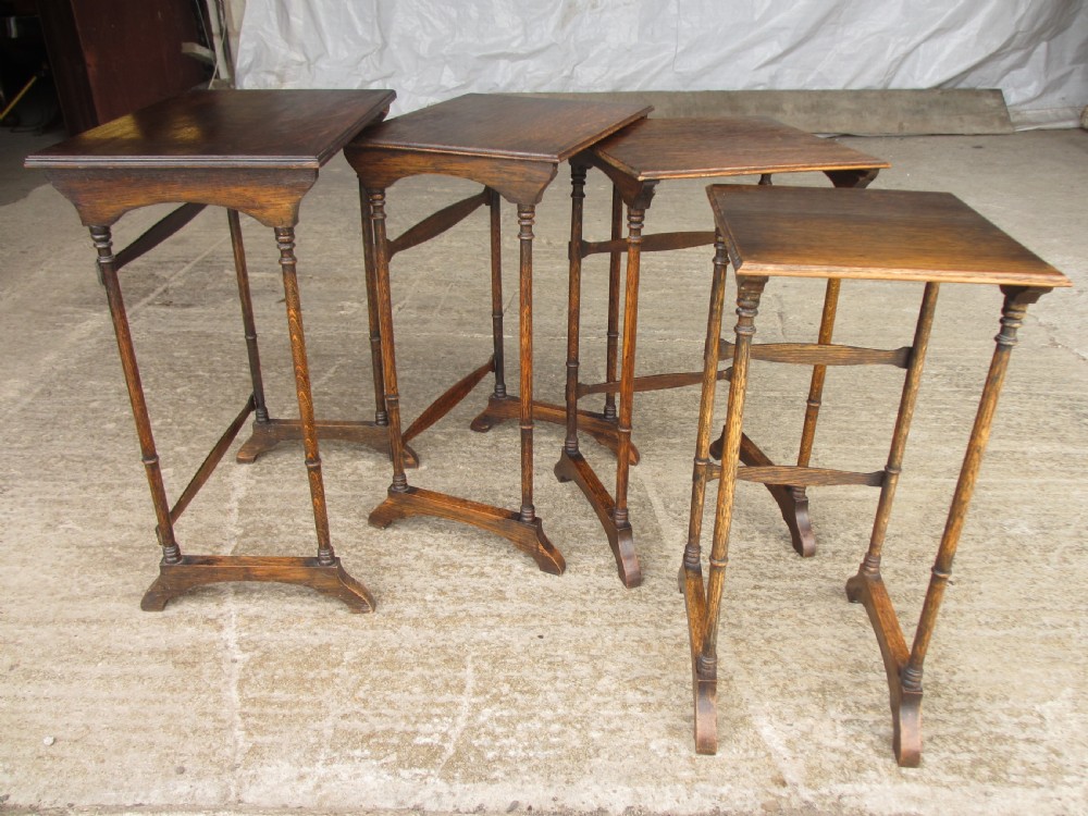 A set of four graduating nineteenth-century oak nesting tables with slender turned legs and rectangular tops. View X