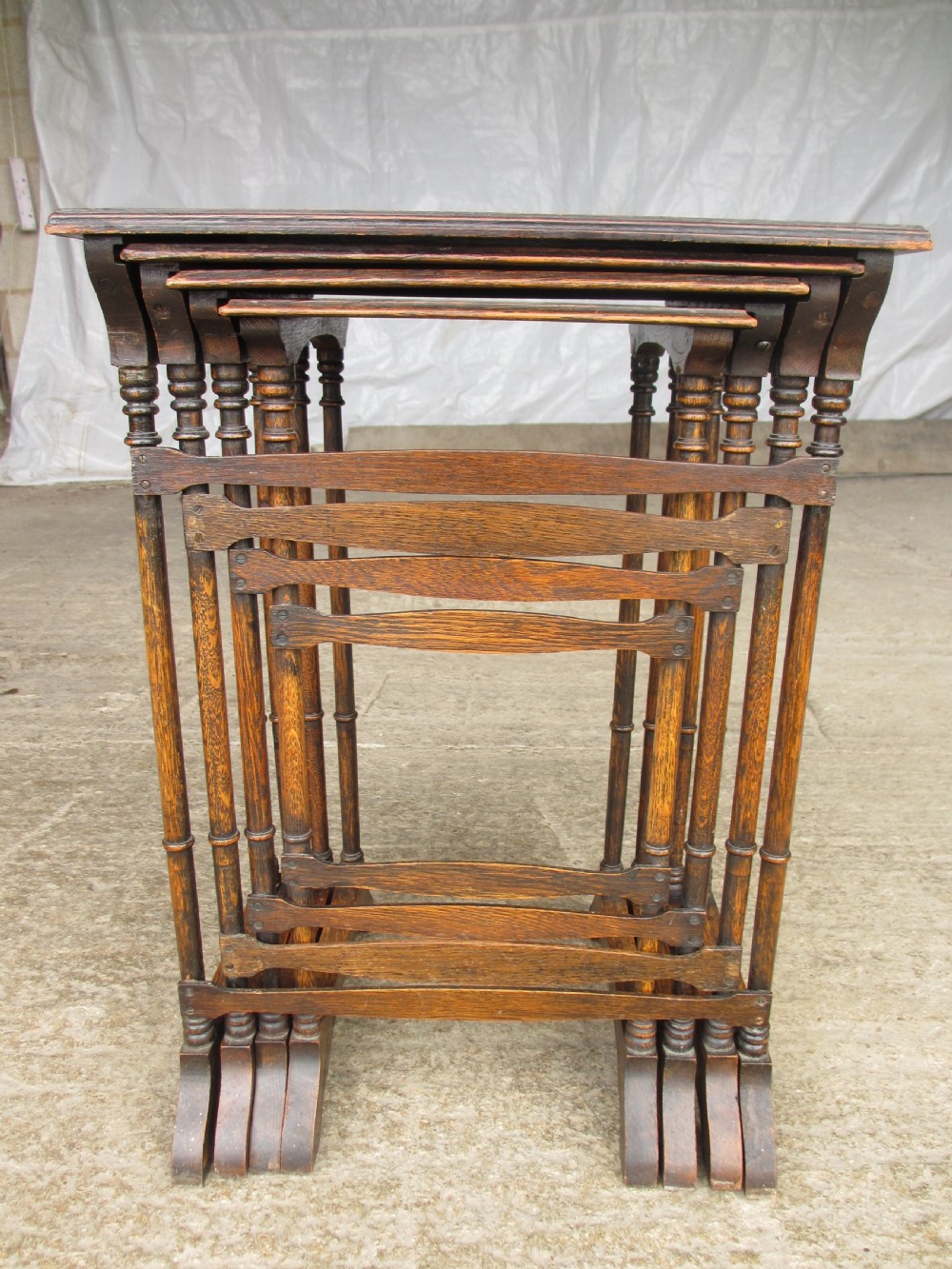 A set of four graduating nineteenth-century oak nesting tables with slender turned legs and rectangular tops. View XII