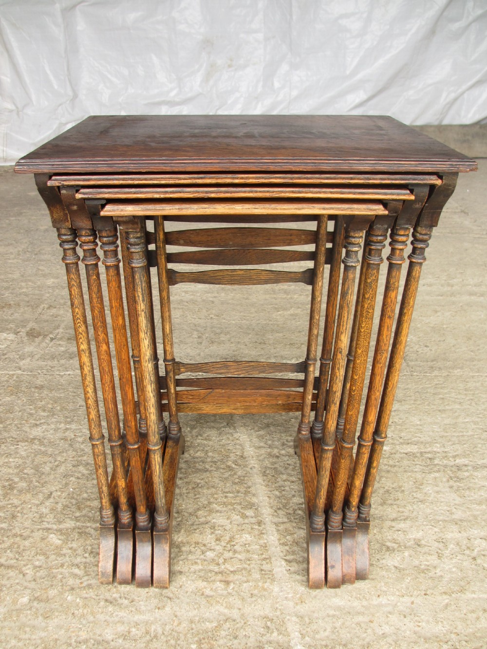 A set of four graduating nineteenth-century oak nesting tables with slender turned legs and rectangular tops. View XIII
