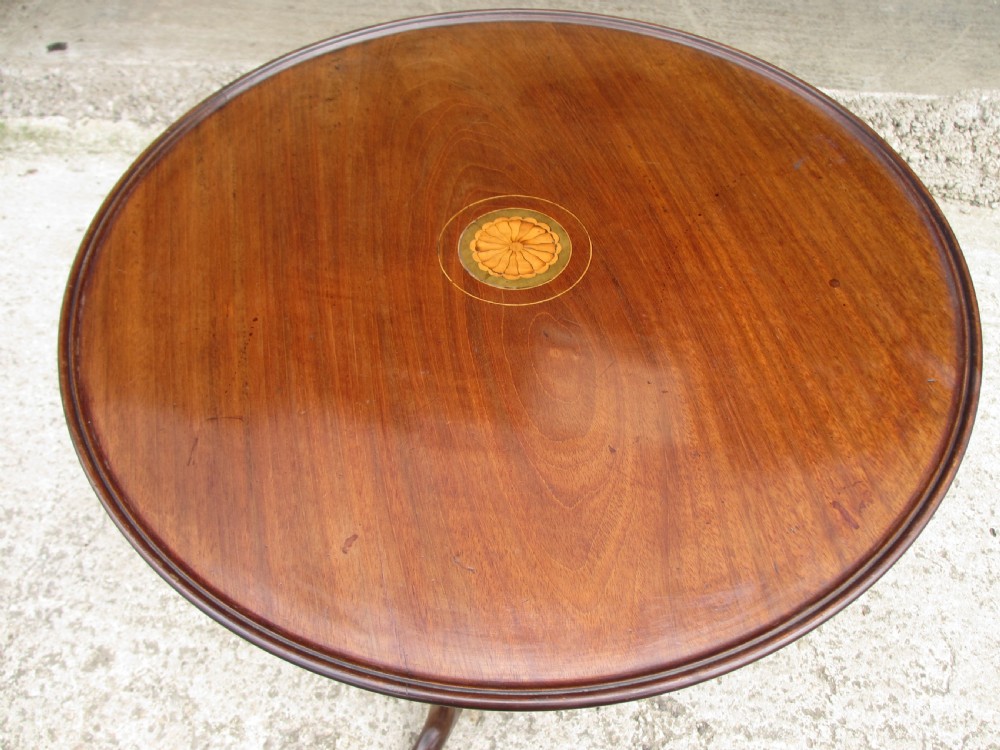 A circular Georgian mahogany tripod table featuring a central inlaid satinwood rosette, turned pedestal stem, and three curved legs. View III