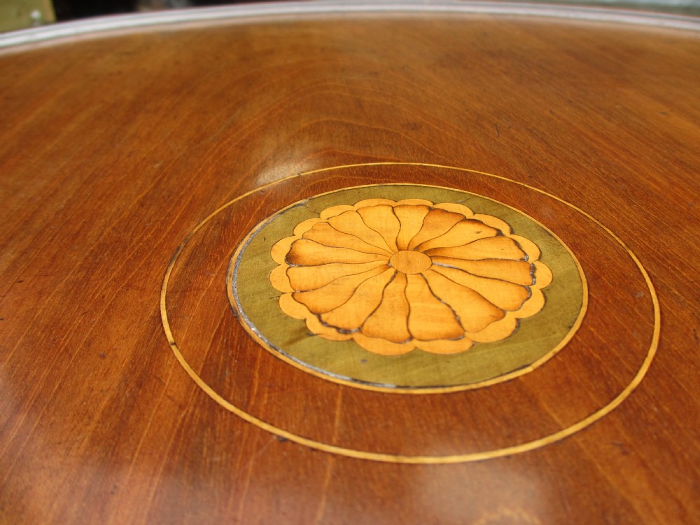 A circular Georgian mahogany tripod table featuring a central inlaid satinwood rosette, turned pedestal stem, and three curved legs. View V