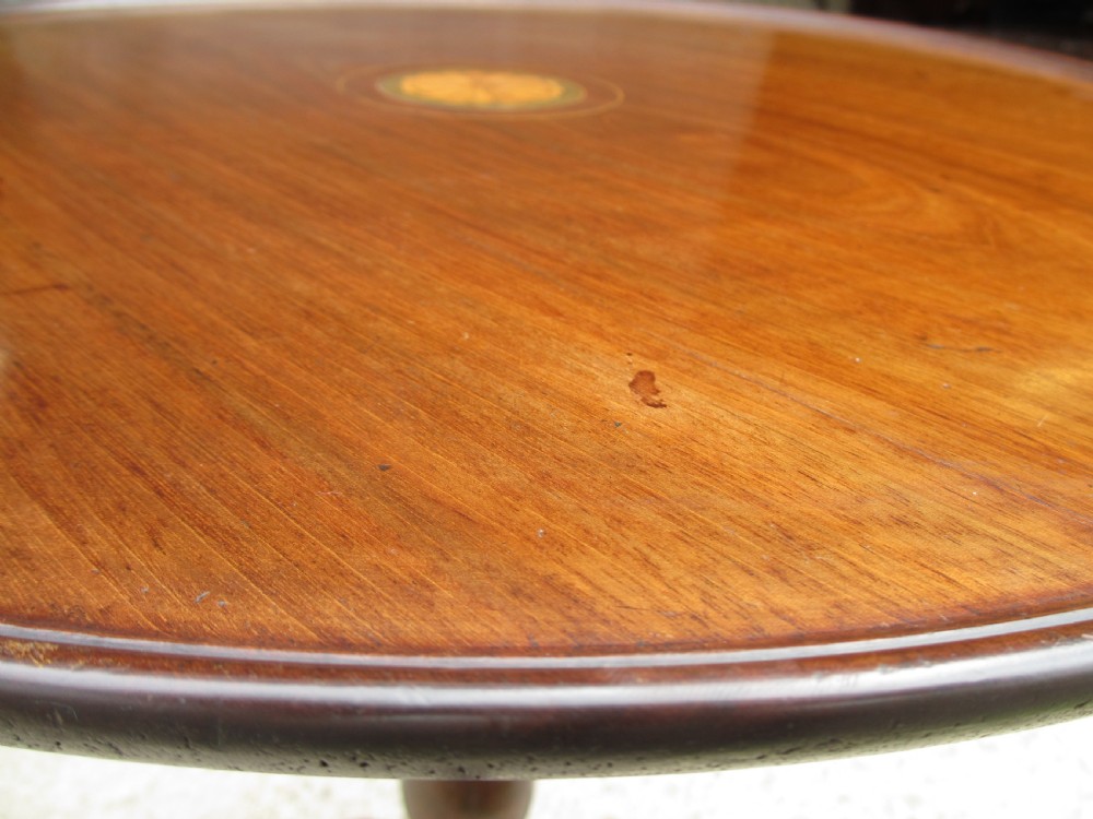 A circular Georgian mahogany tripod table featuring a central inlaid satinwood rosette, turned pedestal stem, and three curved legs. View VII