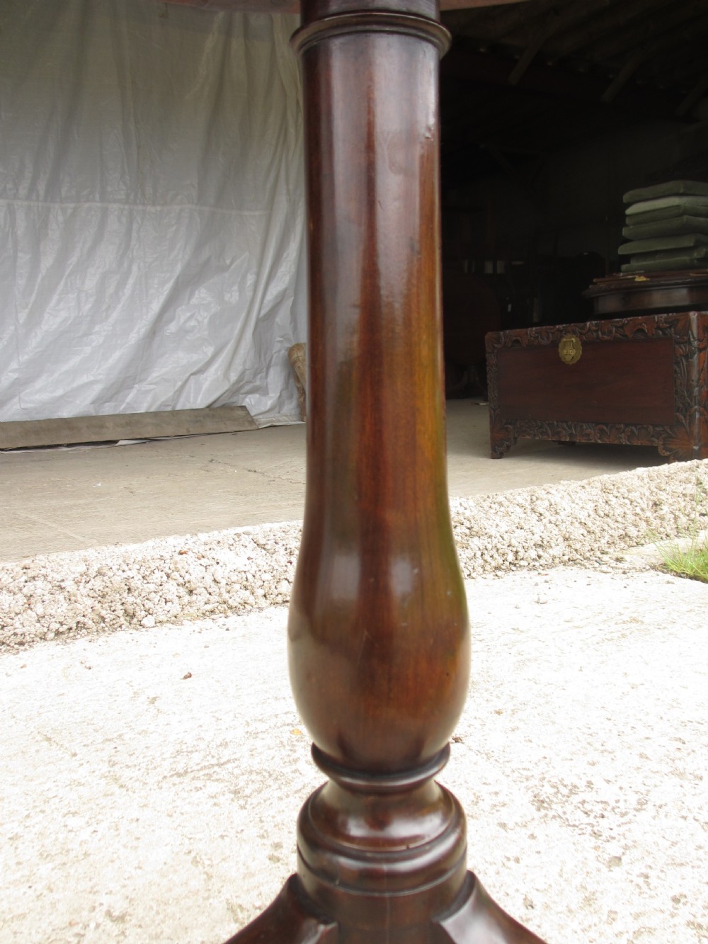 A circular Georgian mahogany tripod table featuring a central inlaid satinwood rosette, turned pedestal stem, and three curved legs. View IX