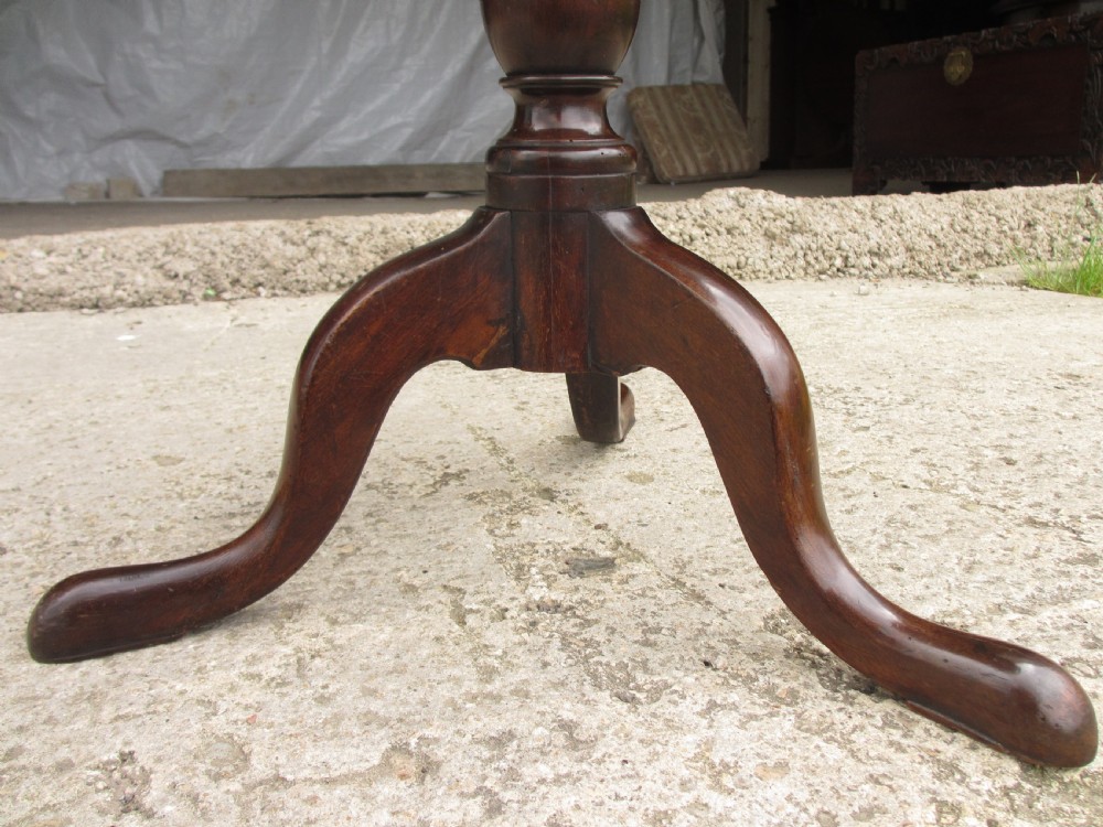 A circular Georgian mahogany tripod table featuring a central inlaid satinwood rosette, turned pedestal stem, and three curved legs. View X