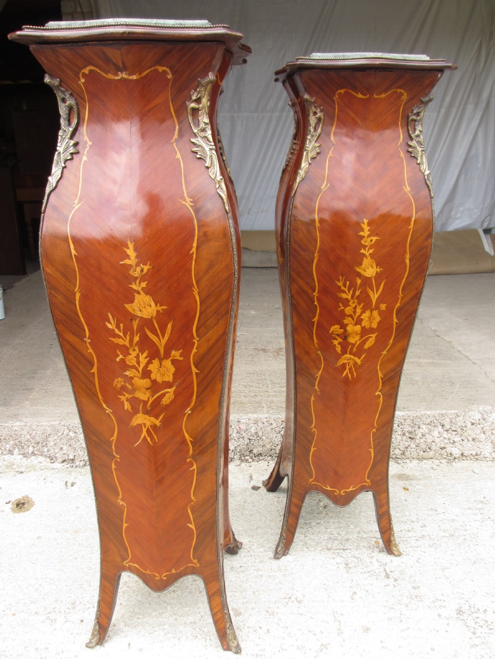 A pair of tall French Louis XV style wooden pedestals featuring floral marquetry inlays, curved silhouettes, and decorative gilt-bronze mounts. View III