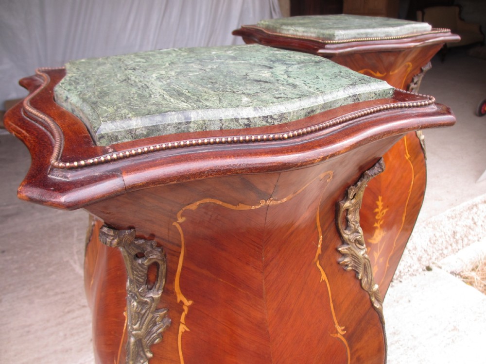 A pair of tall French Louis XV style wooden pedestals featuring floral marquetry inlays, curved silhouettes, and decorative gilt-bronze mounts. View V