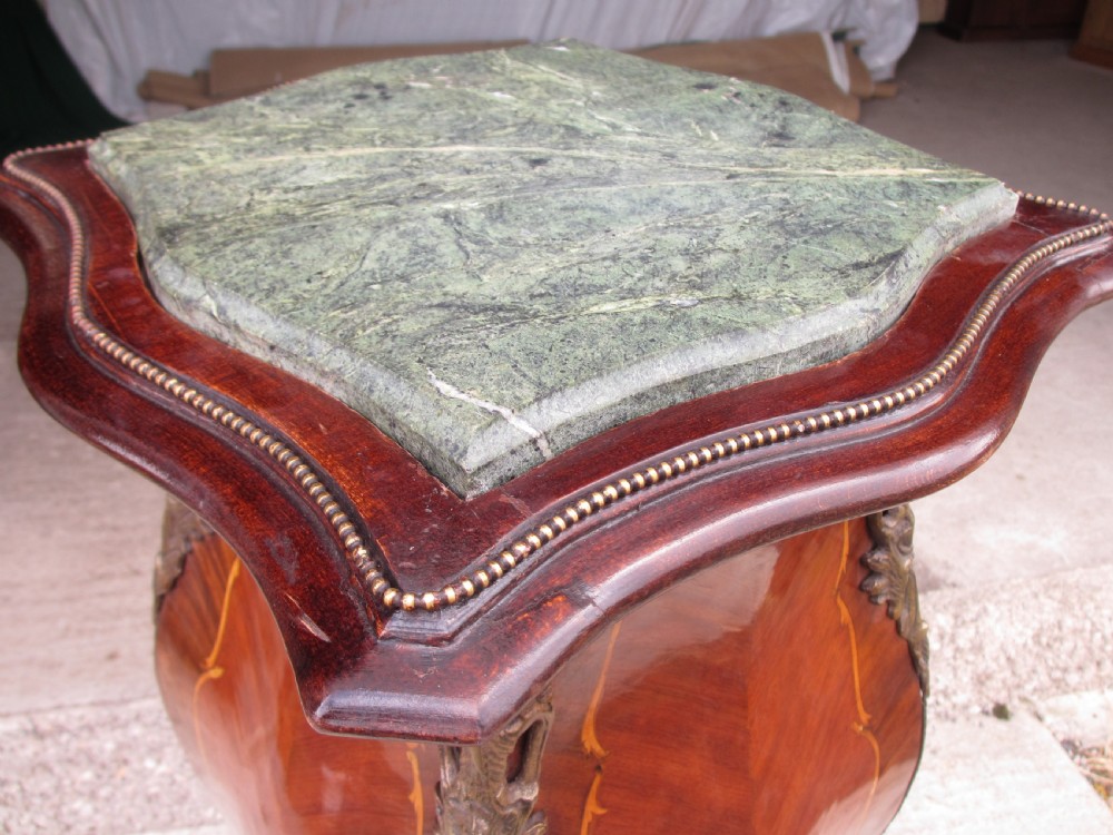 A pair of tall French Louis XV style wooden pedestals featuring floral marquetry inlays, curved silhouettes, and decorative gilt-bronze mounts. View X