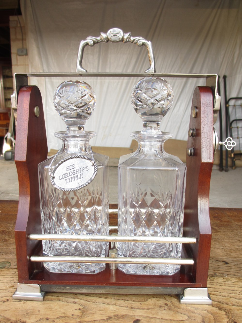 Edwardian 2 bottled Tantalus in a mahogany frame